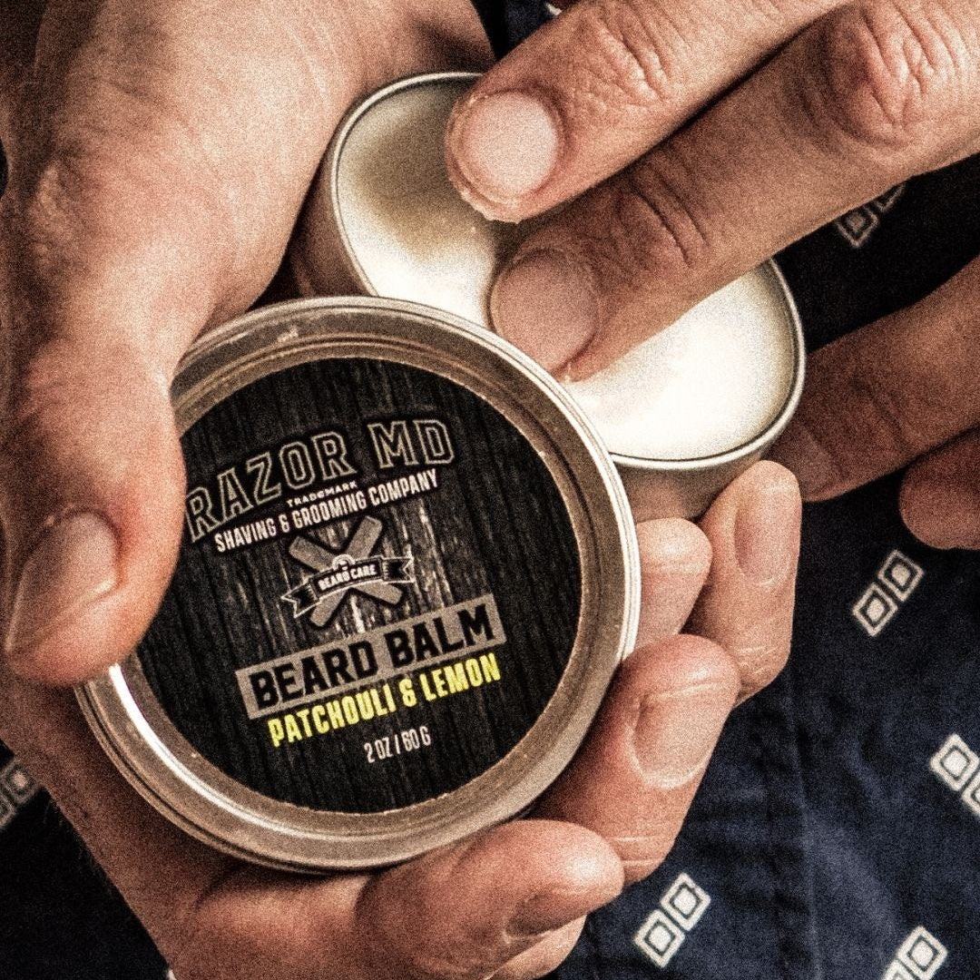 Person holding a container of 'RAZOR MD' beard balm with a focus on the product.